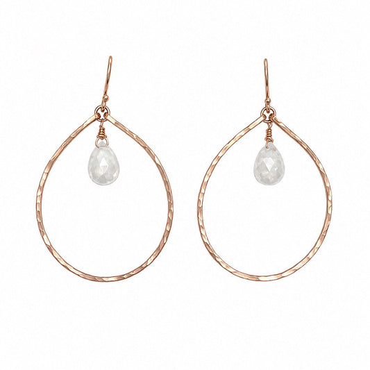 A pair of rose gold teardrop hoop earrings with a small faceted clear teardrop gemstone hanging from the top, shown against a plain white background.